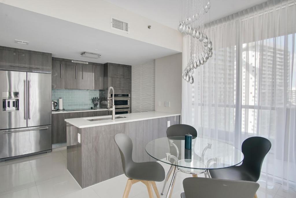 a kitchen with a glass table and chairs at NEW!!! W Brickell Miami- ICON DELUXE LOUNGE with 2 masters in Miami