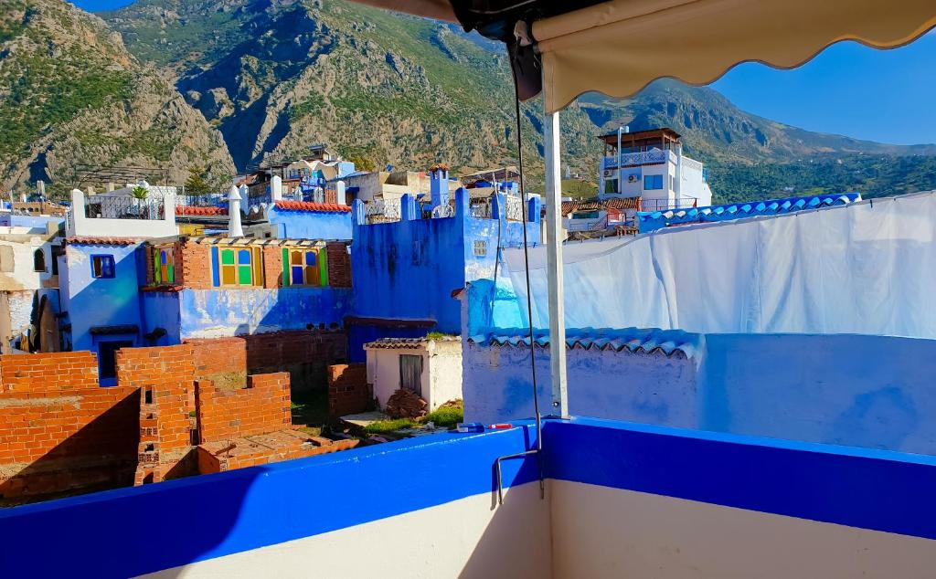 a view of a blue and white city with mountains at Dar Bleu Pearl in Chefchaouene