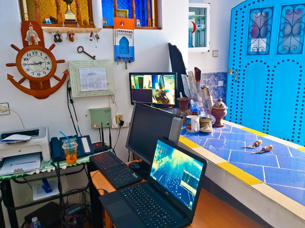 a desk with a laptop and a computer on it at Dar Bleu Pearl in Chefchaouene