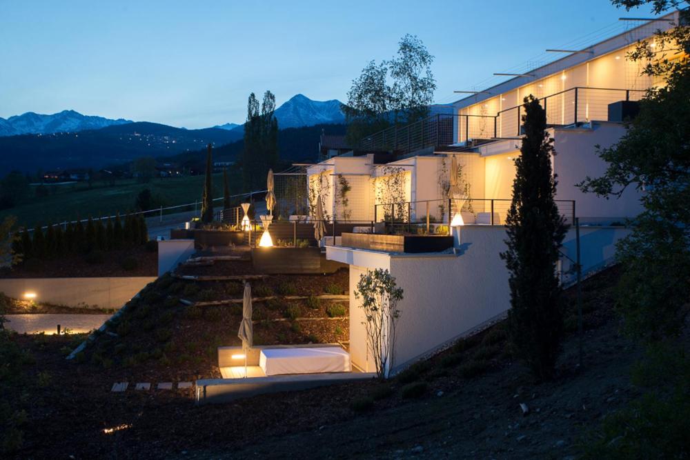 a house with lights on the side of it at night at Villa Grüntaler in Rodengo