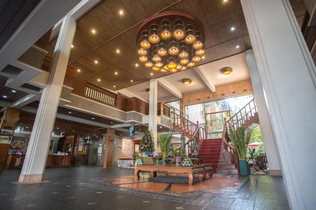 a lobby with a table in the middle of a building at 100 Islands Resort & Spa in Surat Thani