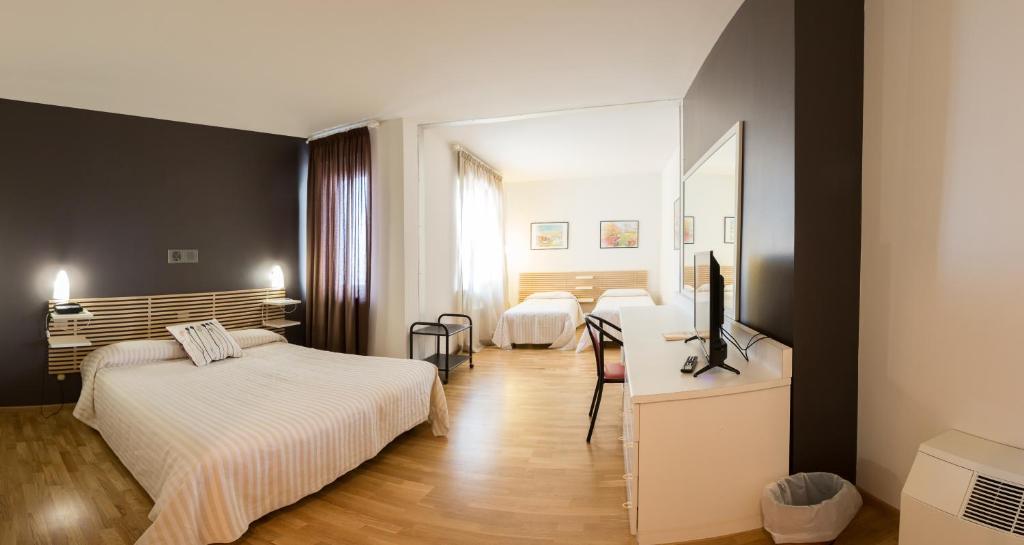 Postel nebo postele na pokoji v ubytování Hotel Quadrifoglio