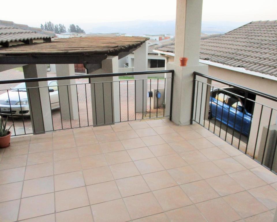 a balcony of a house with a fence at A home away from home in Nelspruit