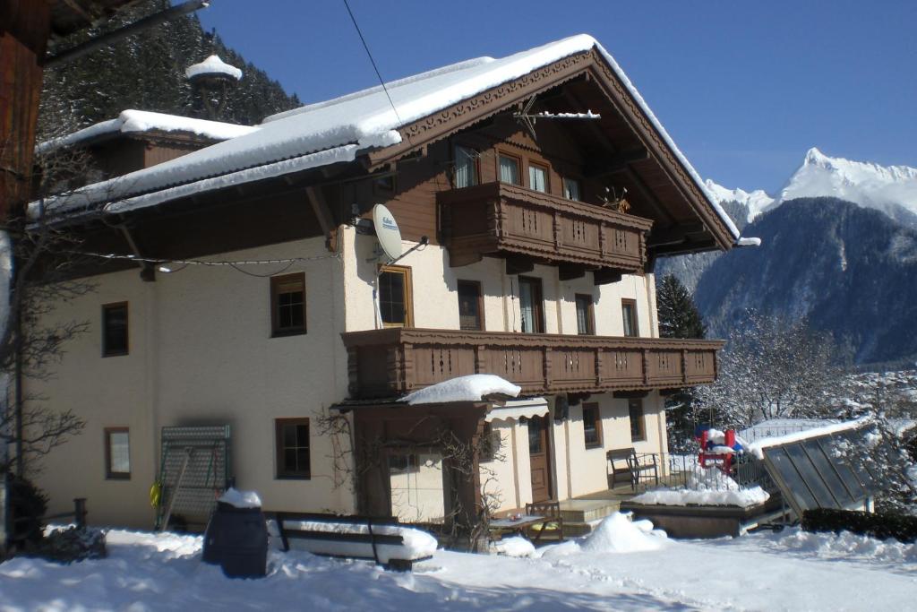 a large house with snow on top of it at Haus Alpengruß in Finkenberg