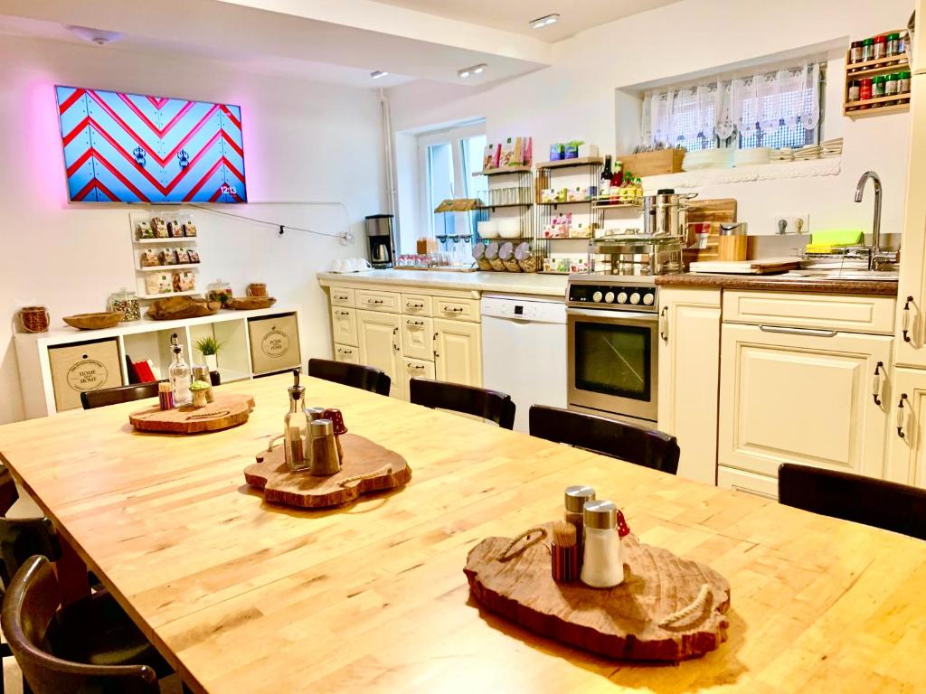 a large kitchen with a wooden table and chairs at New Hostel Berlin Mitte FREE SNACK hot tea and coffee in Berlin