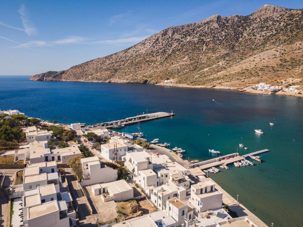 an aerial view of a harbor with white buildings and the water at Podotas Group in Kamares