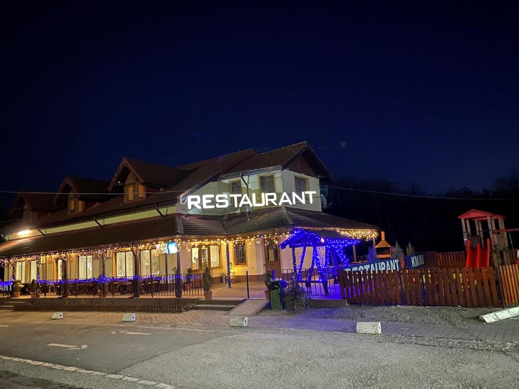 a restaurant with a sign that reads restaurant at night at KM 80 Restaurant & Hotel in Mavrodolu