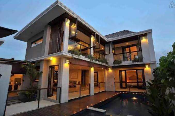 a large house with a swimming pool in front of it at Indah Balangan Villa in Jimbaran