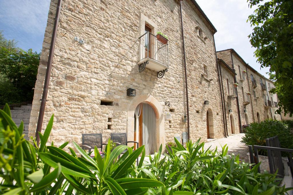 a large stone building with a window and plants at Casa Cristina Bed&Breakfast in Ripabottoni