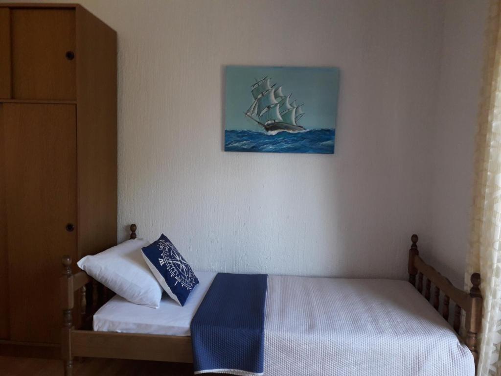 a bedroom with a bed with a pirate ship on the wall at Delfin Apartments in Sveti Juraj