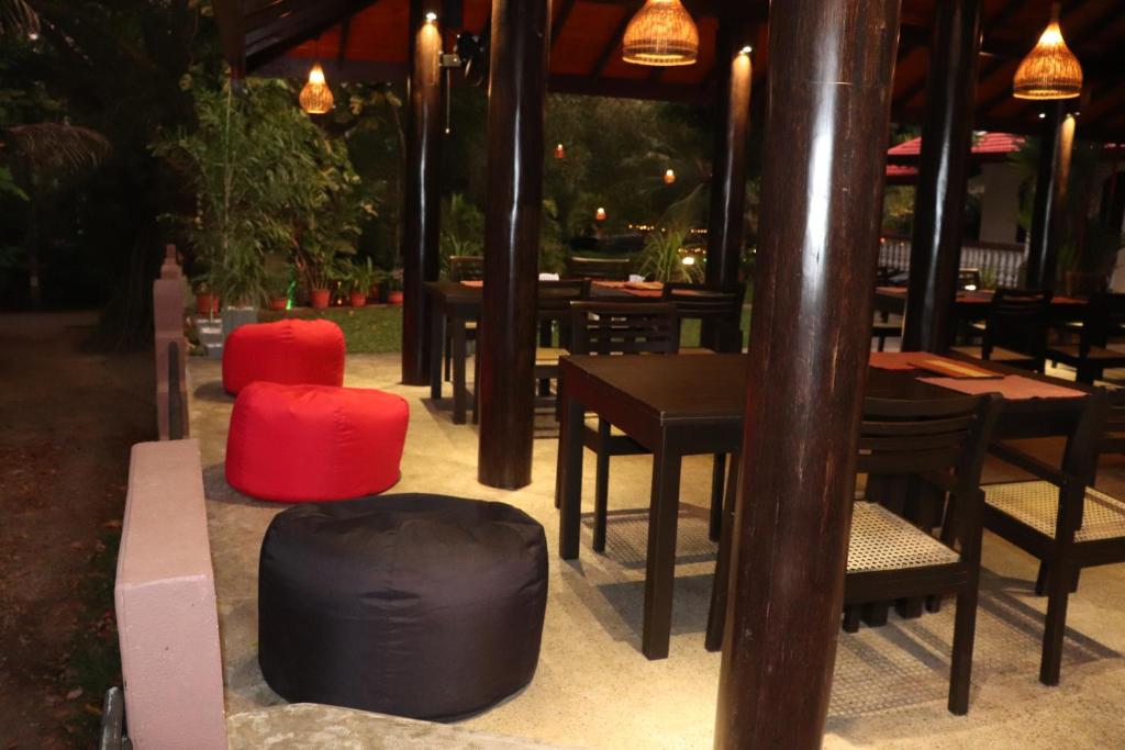 a group of tables and chairs in a restaurant at Goyambokka Guesthouse in Tangalle