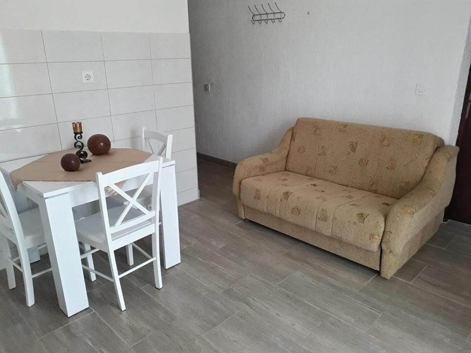 a living room with a couch and a table at Delfin Apartments in Sveti Juraj