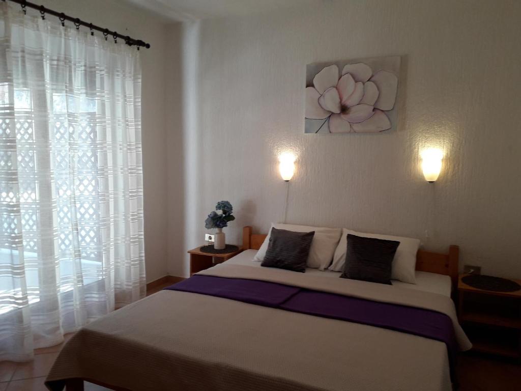 a bedroom with a bed and a large window at Delfin Apartments in Sveti Juraj