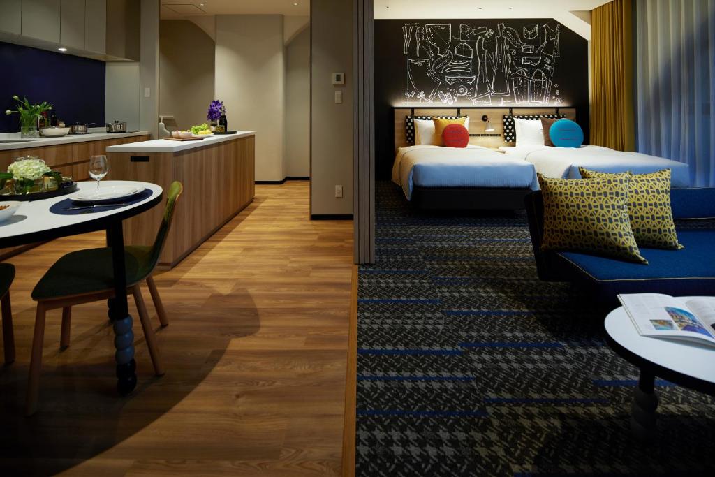 a hotel room with two beds and a kitchen at Citadines Namba Osaka in Osaka