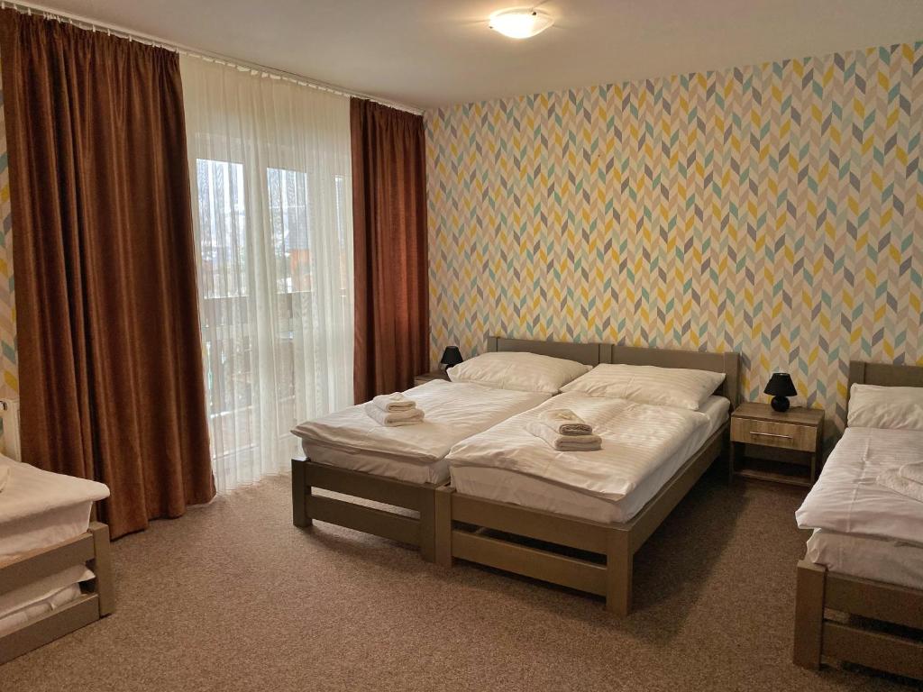 Postel nebo postele na pokoji v ubytování Penzion Panorama