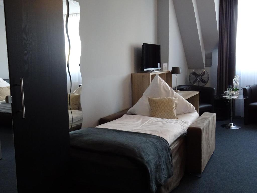 Postel nebo postele na pokoji v ubytování Komm' In Hotel