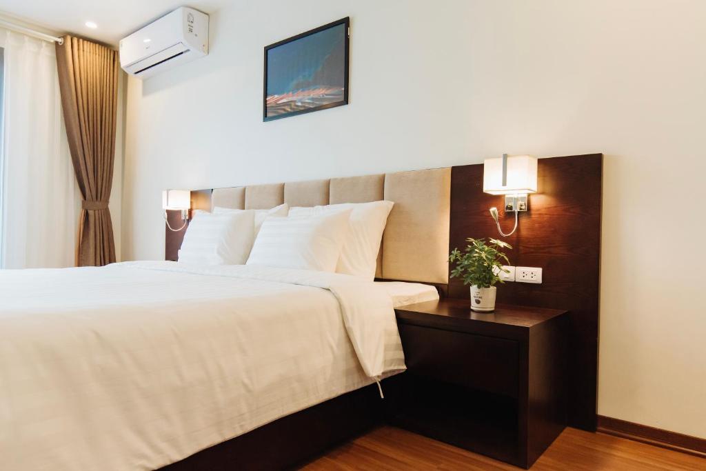 Postel nebo postele na pokoji v ubytování Paragon Noi bai Hotel & Pool