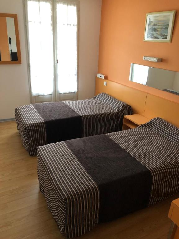 Postel nebo postele na pokoji v ubytování Hôtel Au Petit Languedoc