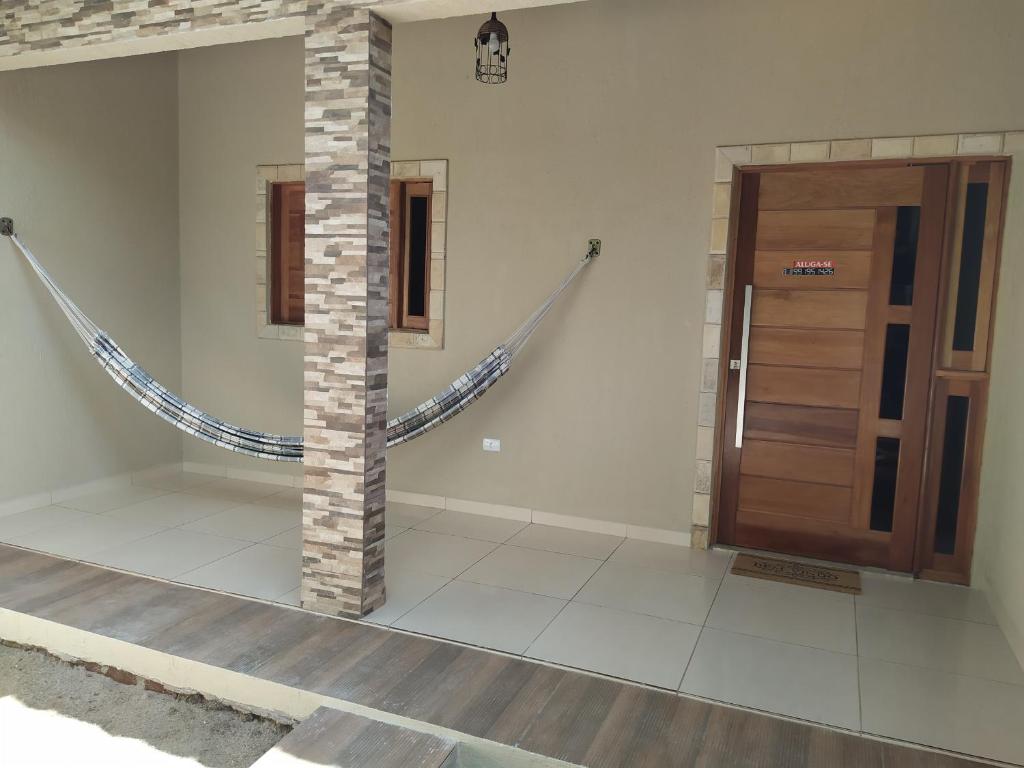 a room with a staircase and a wooden door at Chalés Caribe brasileiro - Chale 2 in Maragogi
