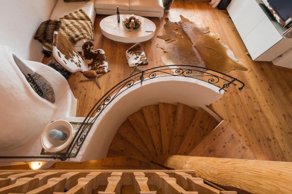 a spiral staircase in a room with a plate of food at Das Kitz - deLuxe Chalet Valerie in Reith bei Kitzbühel