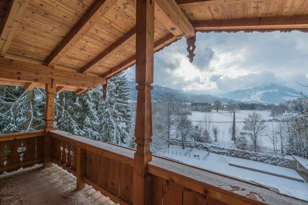 a winter view from the porch of a log cabin at Das Kitz - deLuxe Chalet Valerie in Reith bei Kitzbühel