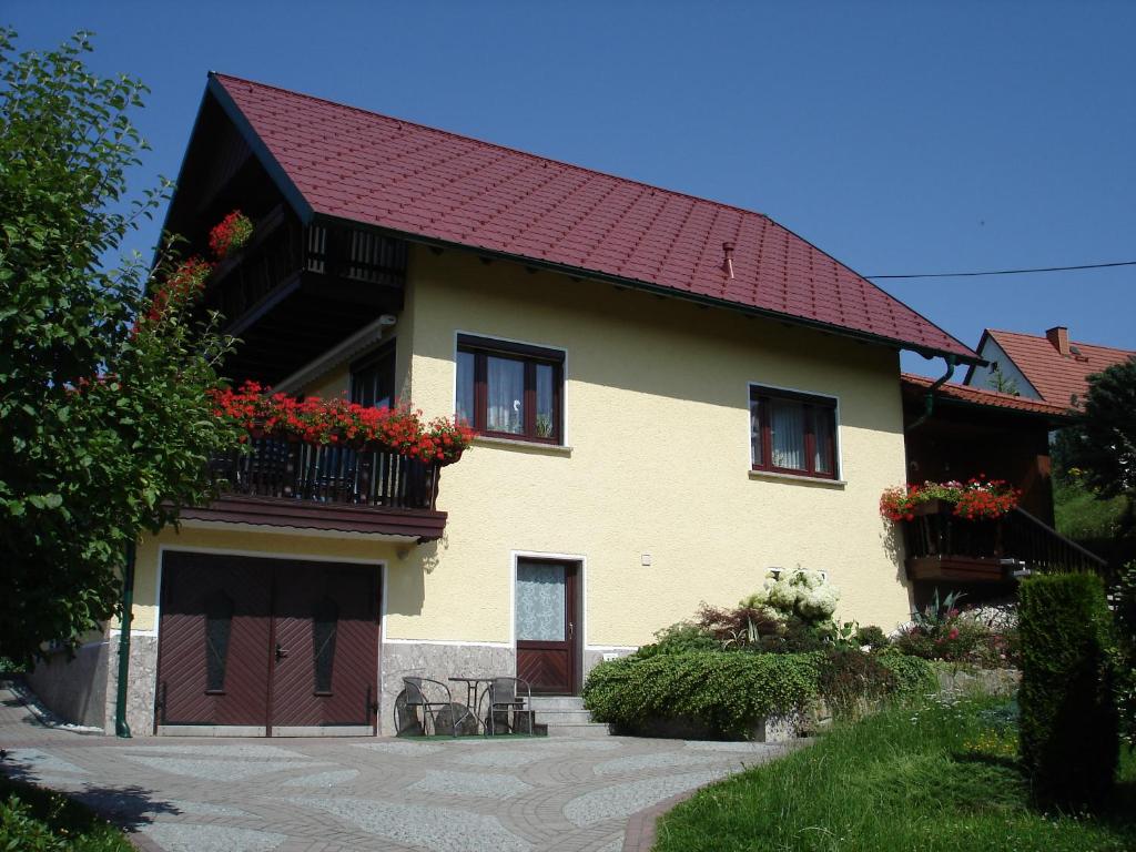 a house with a red roof and a balcony at Haus am Sonnenhang in Wasungen