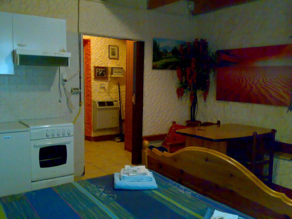 a kitchen with a table and a kitchen with a stove at IANUA COELI 3 in Mosso Santa Maria