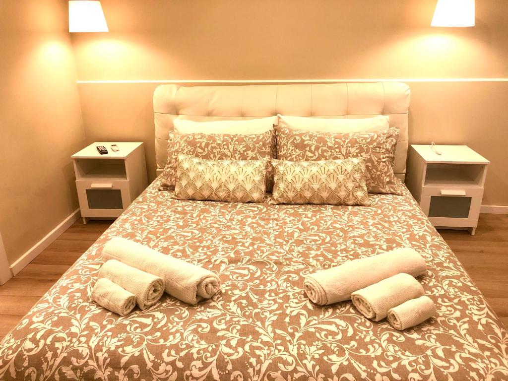 a bedroom with a large bed with four pillows at Borgo Empedocle House in Catania