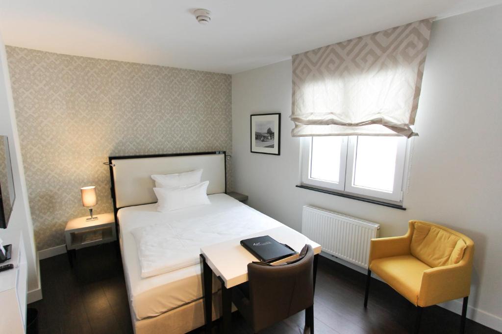 Postel nebo postele na pokoji v ubytování Hotel Wemperhardt