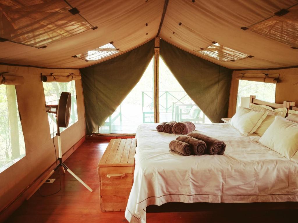 a bedroom with a bed in a tent at Kelora Bush Camp in Hoedspruit