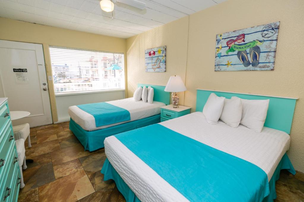 a hotel room with two beds and a window at Aztec Motel in Wildwood Crest