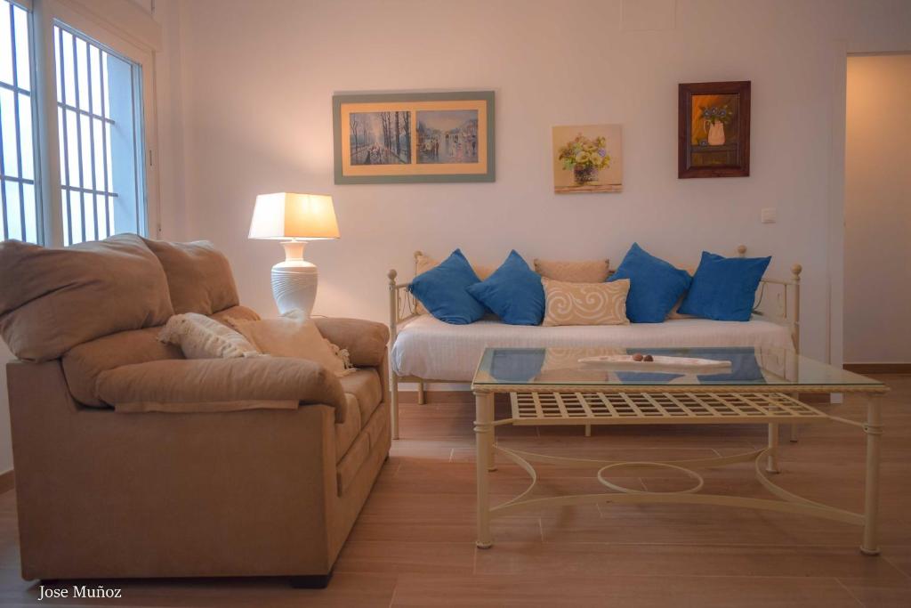 a living room with a couch and a coffee table at Santa Angela de la Cruz in Peñaflor