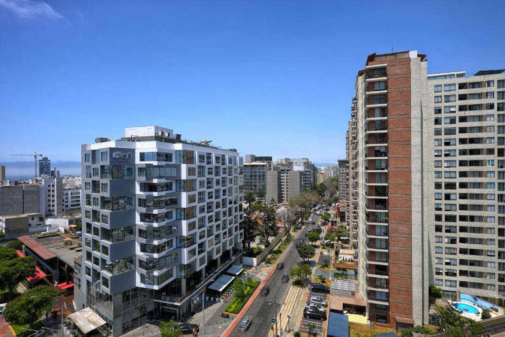 an aerial view of a city with tall buildings at Guernica Apartments in Lima