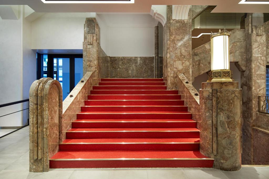 a red carpeted staircase in a building at Citadines Namba Osaka in Osaka