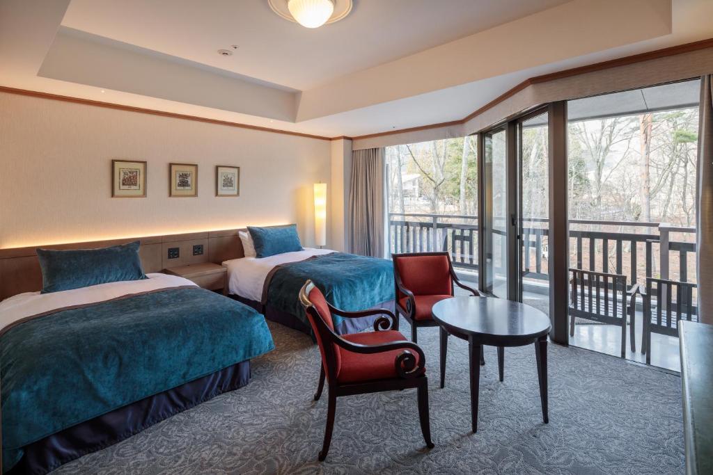 Postel nebo postele na pokoji v ubytování Hakuba Tokyu Hotel