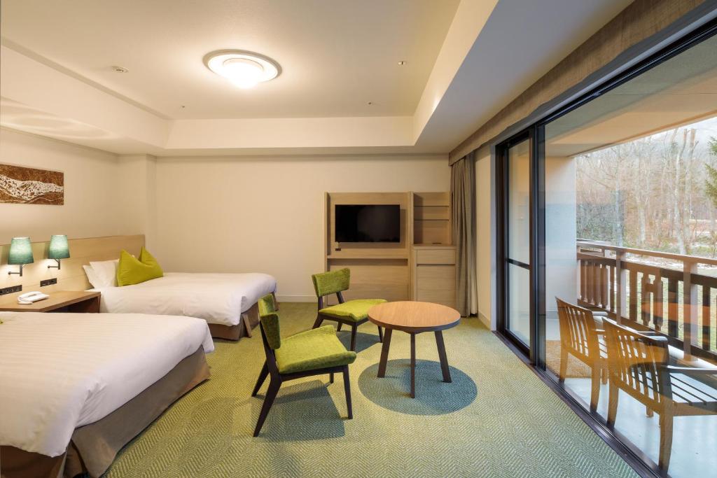 Postel nebo postele na pokoji v ubytování Hakuba Tokyu Hotel