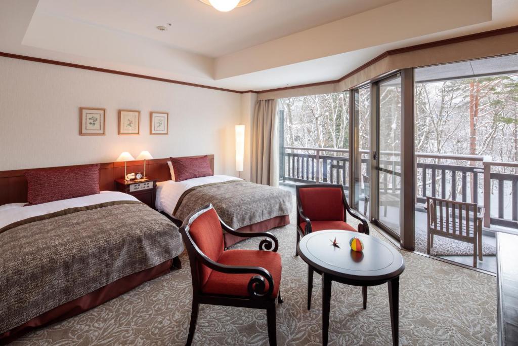 Postel nebo postele na pokoji v ubytování Hakuba Tokyu Hotel