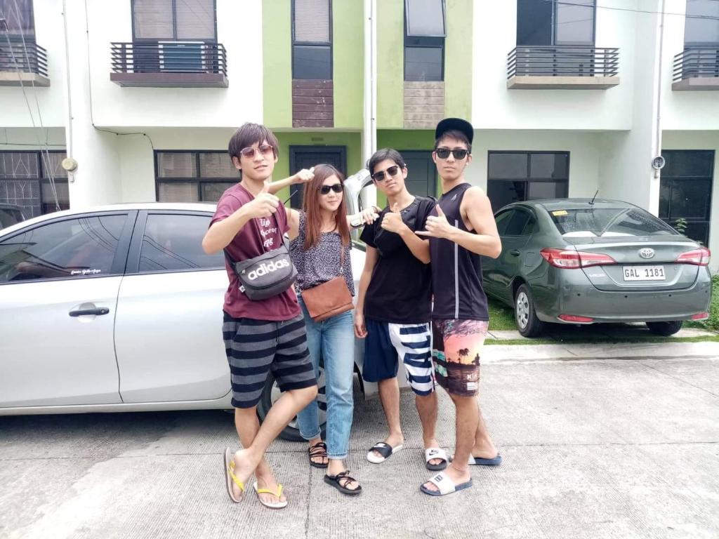 a group of young people standing in a parking lot at Haus of Emerald by JeYo in Mactan