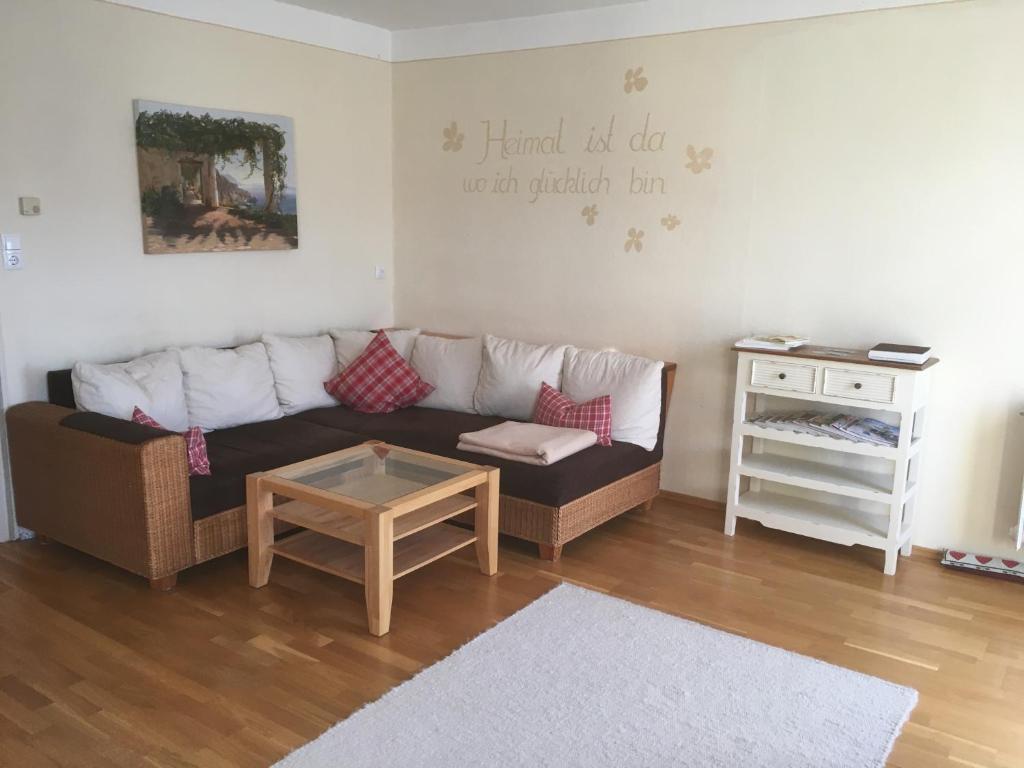 a living room with a couch and a table at Ferienwohnung Rotmesnerhof Seeblick in Schliersee