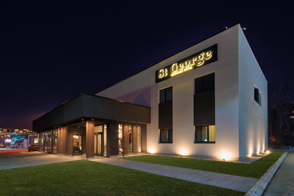 a building with a sign on the side of it at night at Boutique Hotel St Georgije in Banja Luka