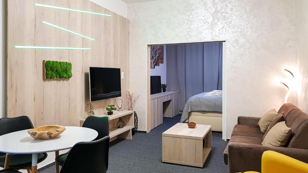 a living room with a couch and a table at Apartment Marco Hrebienok in Smokovce