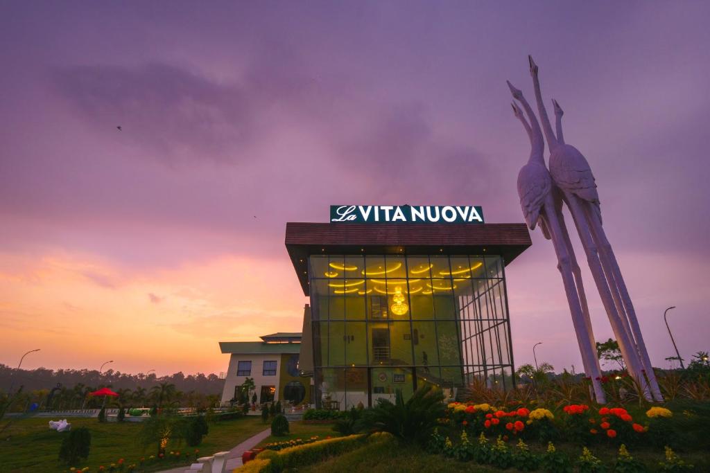 a building with a sign that reads kvl ultra muzico at La Vita Nuova Resort & Spa in Shaugaon