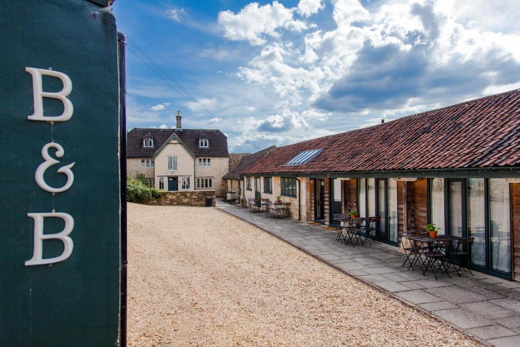 an empty street in a village withb and cottages at T's at Lower Rudloe Farm in Corsham