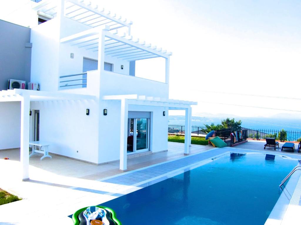 a villa with a swimming pool and a view of the ocean at Luxury Villa with amazing view, Cesme in Cesme