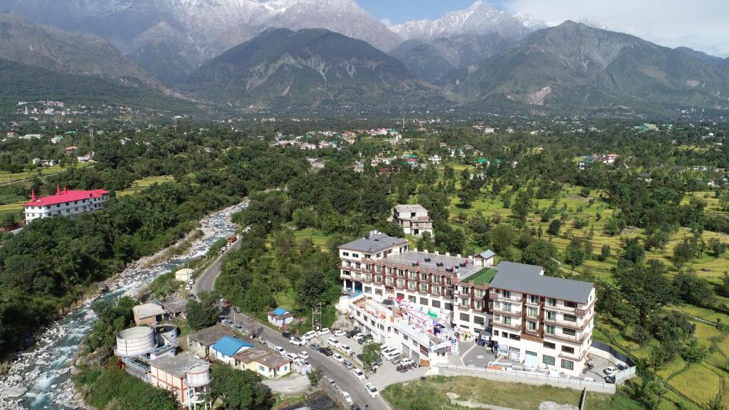 an aerial view of a hotel with mountains in the background at D'Polo Club & Spa Resort in Dharamshala