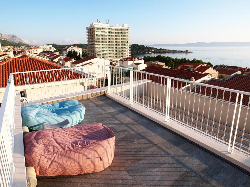 a balcony with a view of the ocean and buildings at Apartments House Filipović in Makarska
