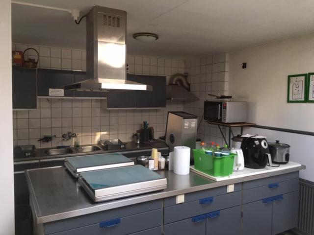a kitchen with a sink and a counter top at Pension Moerdijk in Moerdijk