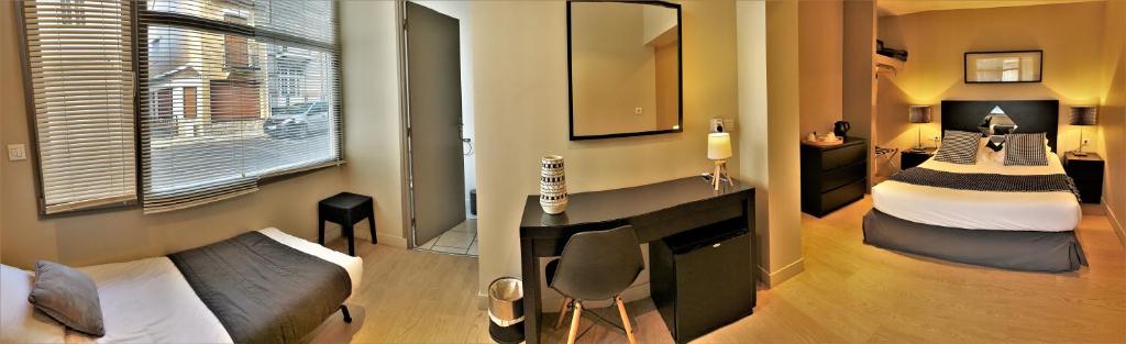 Postel nebo postele na pokoji v ubytování Hôtel Jules