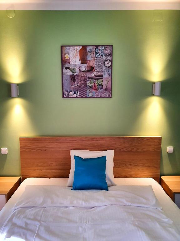 Postel nebo postele na pokoji v ubytování Pannonia Apartman