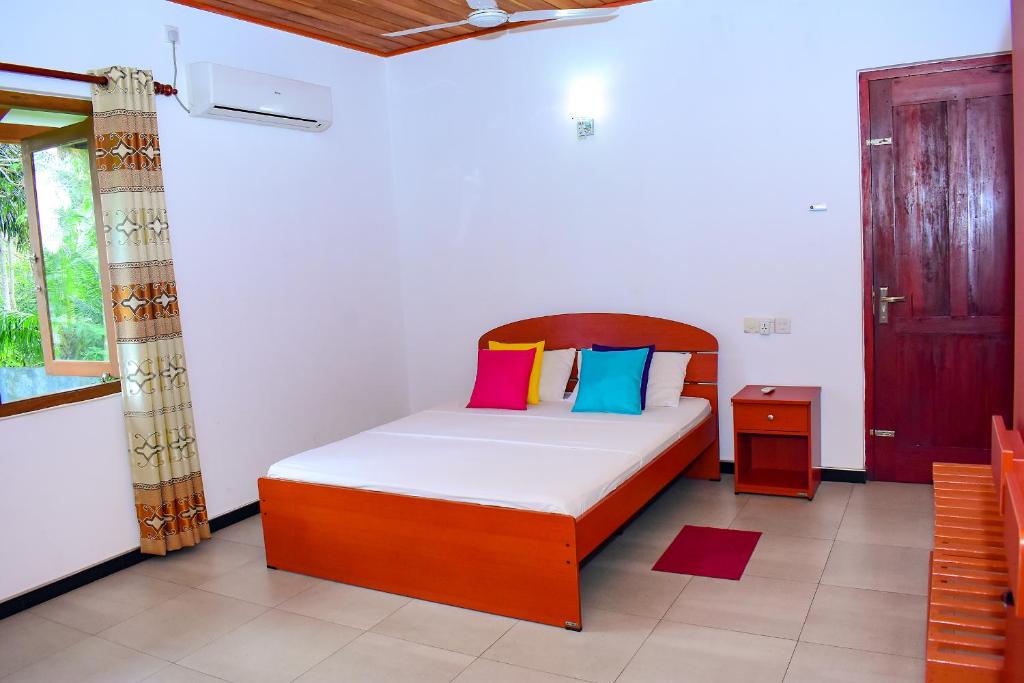 En eller flere senge i et værelse på Megabe Villa